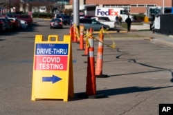 FILE - A sign points to a COVID testing site at the Cincinnati Veterans Affairs Medical Center in Cincinnati, on Jan. 3, 2022.