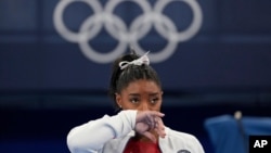 Simone Biles says she wasn't in right 'headspace' to compete and withdrew from gymnastics team final to protect herself. 