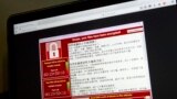 (FILE) A warning screen from a purported ransomware attack, as captured by a computer user in Taiwan, is seen on laptop in Beijing, May 13, 2017. 