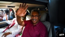 FILE - In this file photo taken on November 17, 2019, Sri Lanka's President-elect Gotabaya Rajapaksa waves to supporters as he leaves the election commission office in Colombo. (Photo by Ishara S. KODIKARA / AFP)