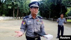 FILE - Border guard police force chief Police Major General Thura San Lwin talks to the media in front of their headquarters in Kyee Kan Pyin village outside Maungdaw, Myanmar, Oct. 26, 2016.