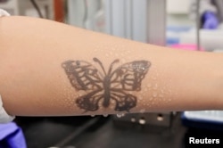 Water sprays on arm are seen with an electronic tattoo (e-tattoo) for the wettability test at the Korea Advanced Institute of Science and Technology (KAIST) in Daejeon, South Korea, July 26, 2022. (REUTERS/Minwoo Park)