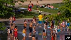 Decenas de niños buscan alivio a una ola de calor en un parque de agua de Madrid, el 17 de junio de 2022. 