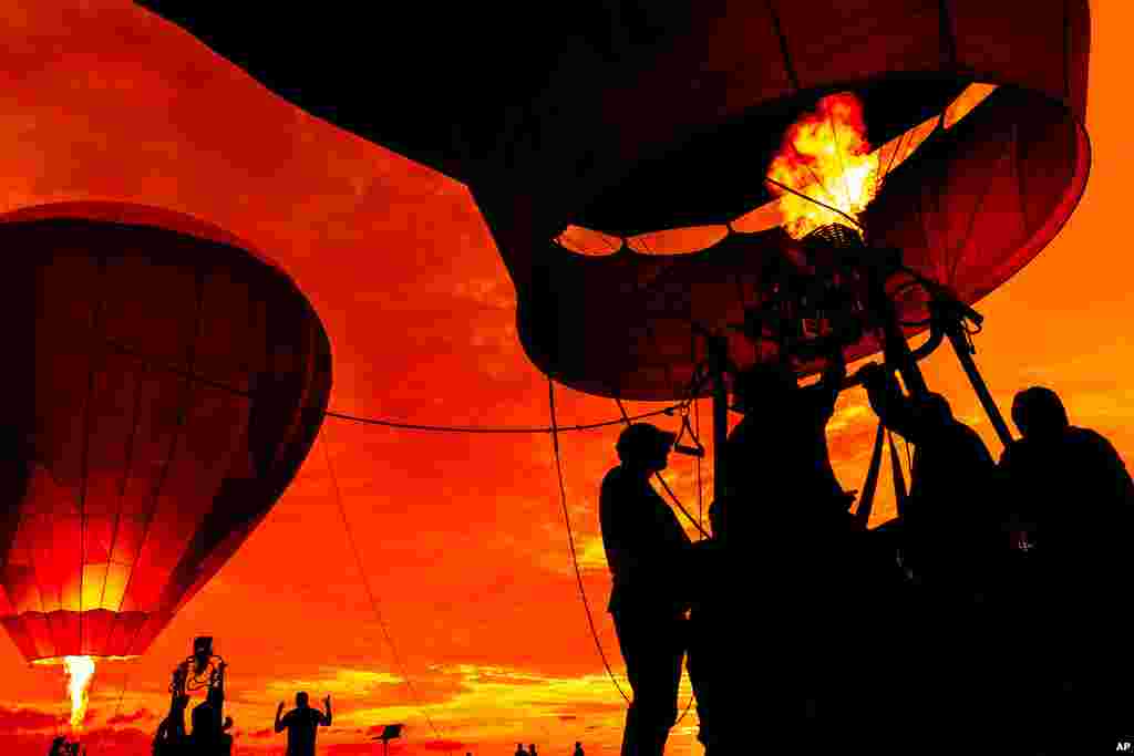 Crews blow up hot air balloons during the 39th yearly New Jersey Lottery Festival of Ballooning at Solberg Airport, in Readington, N.J.