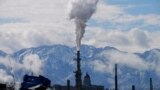 FILE - The Utah State Capitol, rear, is shown behind an oil refinery May 12, 2022, in Salt Lake City.