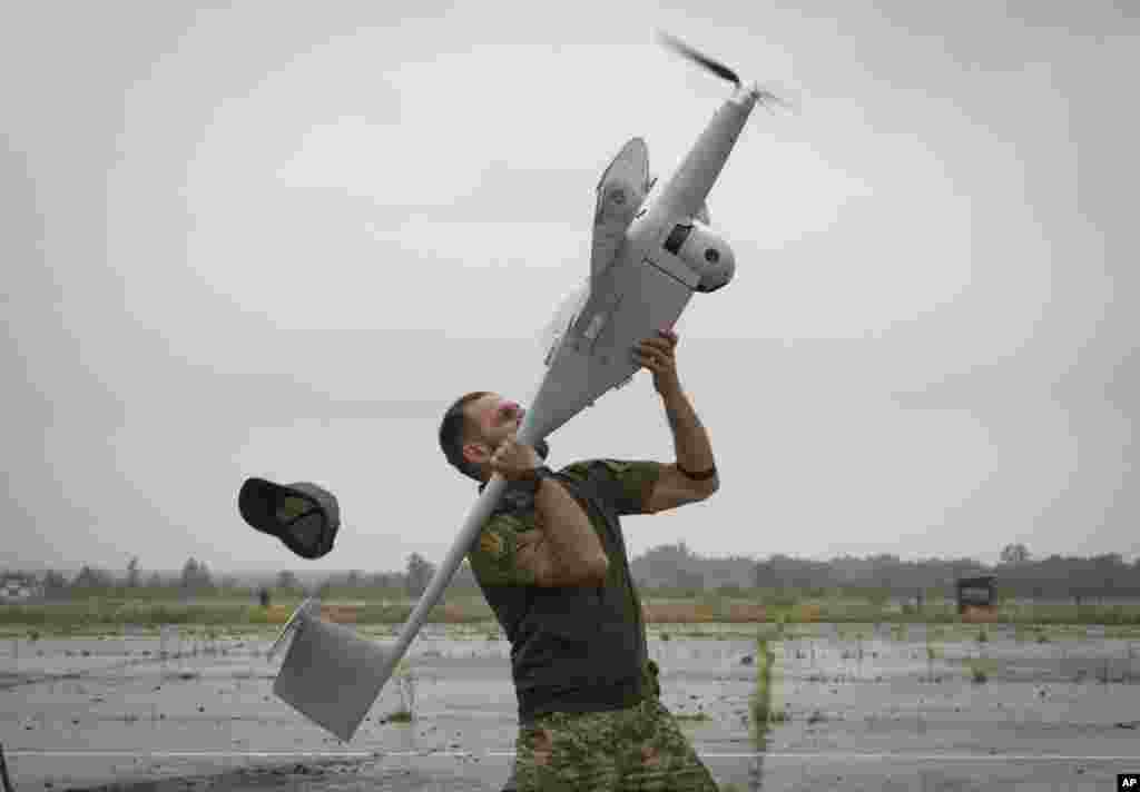 A Ukrainian soldier launches FlyEye WB Electronics SA, a Polish drone, in Kyiv region, Aug. 2, 2022.