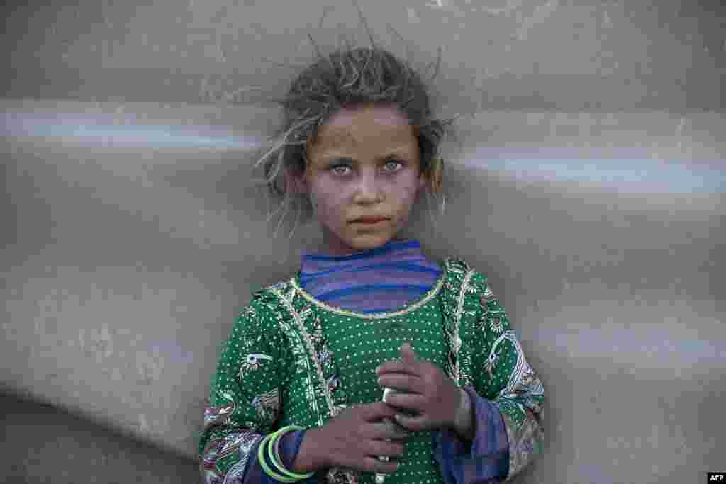 A girl stands at a camp for Syrians displaced by conflict near the Syrian northern city of Raqa, Aug. 2, 2022.