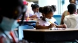 FILE - Laiah Collins, 4, center, works on artworks during a class at Chalmers Elementary School in Chicago, Wednesday, July 13, 2022. (AP Photo/Nam Y. Huh)