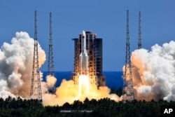 In this photo released by Xinhua News Agency, the Long March 5B Y3 carrier rocket, carrying the Wentian lab module blasts off from the Wenchang Space Launch Center in southern China's Hainan Province Sunday, July 24, 2022. (Li Gang/Xinhua via AP)