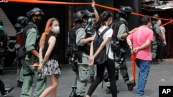 FILE - Police detain protesters after a rally in Causeway Bay before the annual handover march in Hong Kong, July 1, 2020, which marks the date in 1997 when Britain transferred sovereignty over its former colony to China.