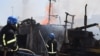 Пожарные ликвидируют последствия российского обстрела порта в Одессе, Украина, 23 июля 2022 года