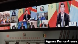 FILE - Chinese President Xi Jinping (on the screen) speaks during the China-Africa Cooperation meeting in Dakar, Senegal, Nov. 29, 2021. In the U.S.-China clash over Taiwan, most African nations stand with Beijing, loathe to alienate the continent's largest trade partner. 