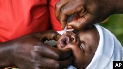 Mwana achidonhedzerwa nhomba yekudzivirira mhetamakumbo, kana kuti polio.