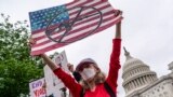 Activists join Senate Democrats outside the Capitol in Washington, to force action on gun control legislation after a gunman killed 19 children and two teachers at a Texas elementary school, May 26, 2022. (AP Photo/J. Scott Applewhite)