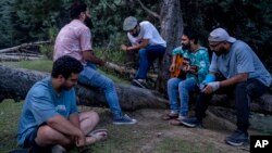 Musicians play songs at a quiet place on the outskirts of Srinagar, Indian-controlled Kashmir, June 14, 2022. (AP Photo/Dar Yasin)