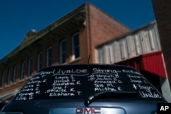 The names of the victims killed in last week's elementary school shooting are written on the back of an SUV near a memorial in Uvalde, Texas, Friday, June 3, 2022. (AP Photo/Jae C. Hong)