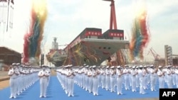 This screen grab made from video released by Chinese state broadcaster CCTV shows the launch ceremony of the Fujian, a People's Liberation Army (PLA) aircraft carrier, at a shipyard in Shanghai on June 17, 2022.