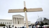 FILE - Anti-abortion activists hold a cross in front of the U.S. Supreme Court building during the annual "March for Life" in Washington, U.S., January 21, 2022. (REUTERS/Jim Bourg/File Photo)