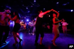 Couples dance at a club in Damascus, Syria, June 13, 2022. (AP Photo/Omar Sanadik)