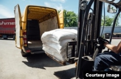 This photo shows food aid being loaded into a van to be delivered to people in need in Ukraine. Ride-sharing company Uber developed and donated a version of its software to help the United Nations' World Food Program deliver food in cities in Ukraine. (Uber)