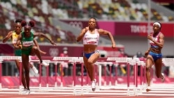 Jasmine Camacho-Quinn, of Puerto Rico, center, races to the line to win the gold in the women's 100-meters hurdles final at the 2020 Summer Olympics, Monday, A