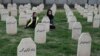 (FILE) Kurdish women sit in the cemetery, where those killed in the Halabja Chemical attack in 1988 are buried in Baghdad, Iraq.