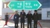 South and North Korean officials unveil the sign of Seoul to Pyeongyang during a groundbreaking ceremony for the reconnection of railways and roads at the Panmun Station in Kaesong, North Korea, Dec. 26, 2018. (Yonhap via Reuters)