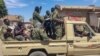 (FILE) Supporters of the Sudanese armed popular resistance, which backs Sudan's army, ride on trucks in Gedaref in eastern Sudan on March 3, 2024.