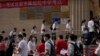 FILE - Students line up to enter a school for the first day of China's national college entrance examinations, in Beijing on June 7, 2022. After the pandemic, young Chinese are again looking to study abroad.