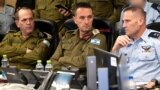 This handout picture released by the Israeli Army shows the head of the military, Lieutenant General Herzi Halevi (C), attending early on April 14, 2024 a meeting at the Israeli Air Force Operations Center in Kirya in Tel Aviv with the commanding officers