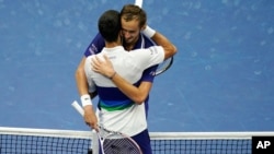 Daniil Medvedev, of Russia, right, hugs Novak Djokovic, of Serbia, after defeating Djokovic during the men's singles final of the US Open tennis championships, Sept. 12, 2021, in New York.