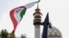 Iranians lift up a flag and the mock up of a missile during a celebration following Iran's missiles and drones attack on Israel, on April 15 2024, at Palestine square in central Tehran.