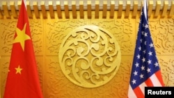 FILE - Chinese and U.S. flags are set up for a meeting at China's Ministry of Transport in Beijing, April 27, 2018. 