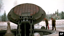 Russian military officials, no names given, look into an open silo of an intercontinental ballistic Topol-M missile at an undisclosed location in Russia in this 2001 photo. Russia has deployed a fresh batch of its top-of-the-line strategic nuclear missil
