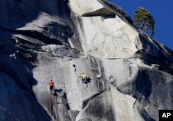 Kevin Jorgeson, left, and Tommy Caldwell climb El Capitan, Wednesday, Jan. 14, 2015, as seen from the valley floor in Yosemite National Park