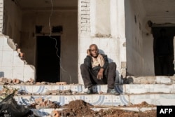 FILE—A man sits among the rubbles of a house during a planned demolition in the historical Piazza neighbouhood of Addis Ababa on March 17, 2024.