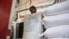 Un trabajador palestino vacía sacos de harina donados por el Programa Mundial de Alimentos (PMA) en una panadería en la ciudad de Gaza el 14 de abril de 2024, en medio del conflicto en curso entre Israel y el grupo militante Hamás.