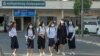 A group of students walks to school on the first day of a new academic year, in Phnom Penh Cambodia, January 11, 2021. (Tum Malis/VOA Khmer)