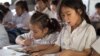 FILE - Primary students are reading during a classroom session at Kesararam primary school, in Siem Reap province, on Friday, March 20, 2015. (Nov Povleakhena/VOA Khmer)
