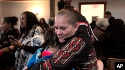 Jessie "Little Doe" Baird (R) hugs a member of the audience following celebration at the Old Indian Meeting House, in Mashpee, Mass., Nov. 18, 2017. Baird and other linguists are working to reclaim the language of the Wampanoags.