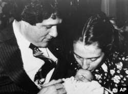 FILE - Gov. Bill Clinton, wife Hillary Rodham, and week-old baby Chelsea pose for a family picture, March 5, 1980. It's the couple's first child. (AP Photo/Donald R. Broyles)