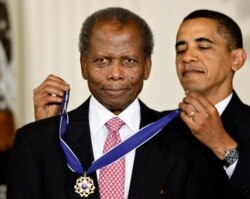 FILE - President Barack Obama presents Sidney Poitier with the 2009 Presidential Medal of Freedom during a ceremony in the East Room of the White House in Washington on August 12, 2009.