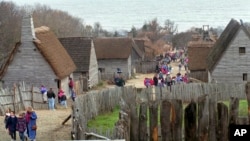 FILE — In this Monday, Nov. 20, 1995 file photo, tourists and students on field trips walk the main entry path through the Plimoth Plantation living history museum village, in Plymouth, Mass., where visitors can get a glimpse into the world of the 1627 Pi