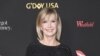 FILE - In this Jan. 27, 2018 file photo, Olivia Newton-John attends the 2018 G'Day USA Los Angeles Gala at the InterContinental Hotel Los Angeles. Two collectors said you’re the one that I want to Newton-John’s iconic “Grease” leather jacket and skintight