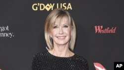FILE - In this Jan. 27, 2018 file photo, Olivia Newton-John attends the 2018 G'Day USA Los Angeles Gala at the InterContinental Hotel Los Angeles. Two collectors said you’re the one that I want to Newton-John’s iconic “Grease” leather jacket and skintight