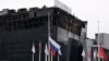 A Russian national flag flutters at half-staff in front of the Crocus City Hall in Krasnogorsk, suburban Moscow, on March 29, 2024, a week after a deadly attack by gunmen on the concert hall. U.S. officials say that the Islamic State-Khorasan was behind the rampage.