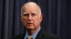 California Gov. Jerry Brown stands next to the podium before signing a budget bill, June 27, 2018, in Los Angeles. Brown granted pardons to 36 people in the past week, including three facing deportation to Cambodia.
