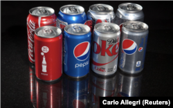 FILE - Soda, pop, or Coke? Regular and mini cans of Coke and Pepsi are pictured in this photo illustration in New York, August 5, 2014. (REUTERS/Carlo Allegro/File Photo)