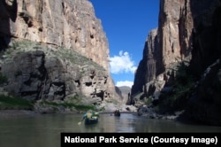 People are seen boating through Mariscal Canyon in Big Bend National Park
