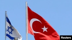 FILE - A Turkish flag flutters atop the Turkish embassy as an Israeli flag is seen nearby, in Tel Aviv, Israel, June 26, 2016. 